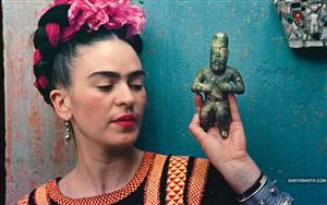 Mexican painter Frida Kahlo with an artifact